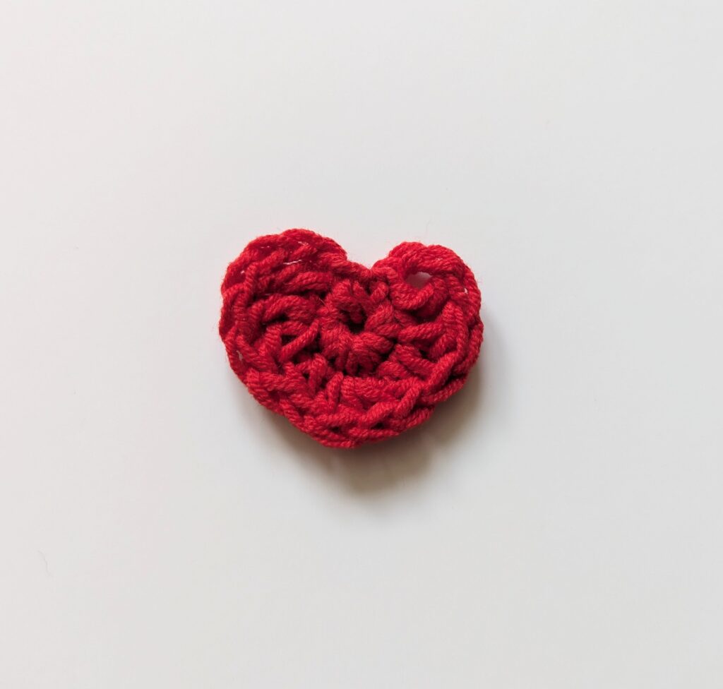 A small red crocheted heart