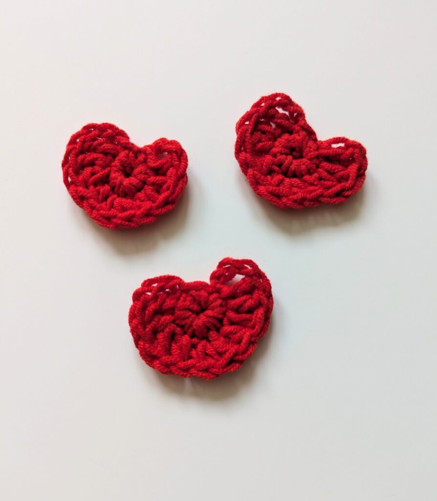 Three red crocheted hearts